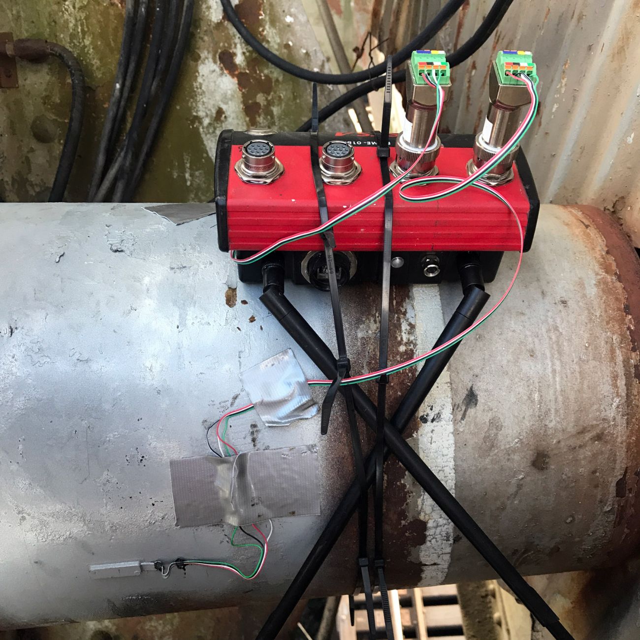 BDI STS4-4-IW3 intelliducer data acquisition node for structural testing installed on a pipe with terminal connectors plugged in.