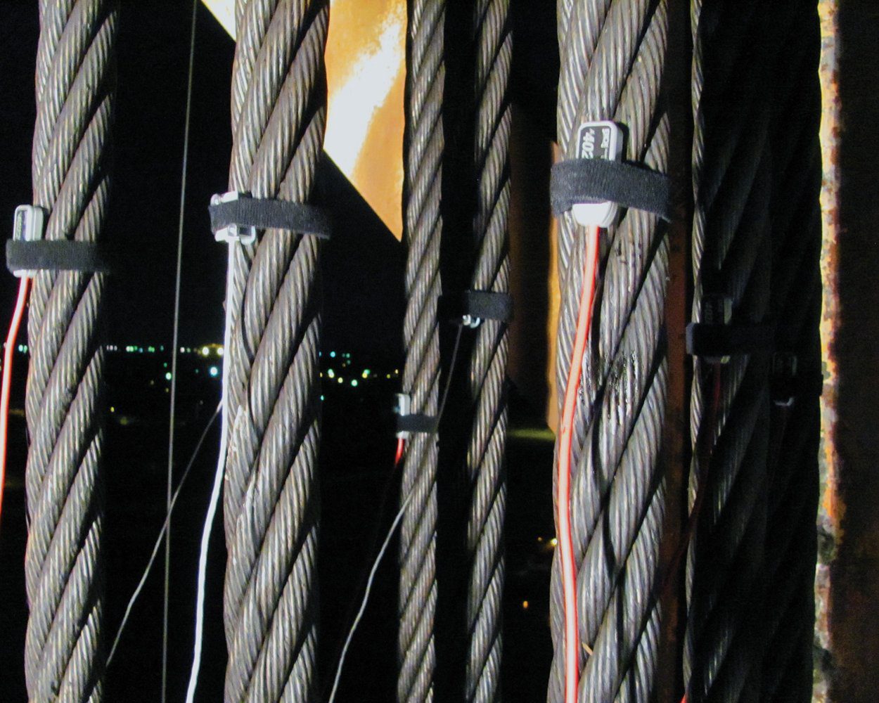 BDI Accelerometers installed on lift span cables with Velcro straps.